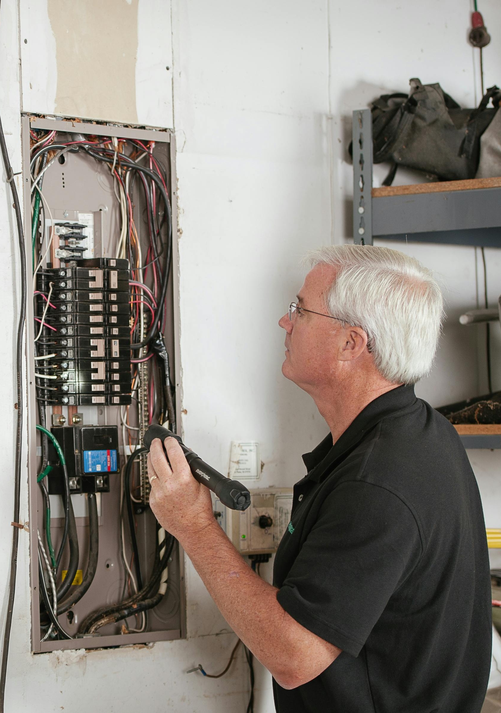 Technician inspecting an electrical panel